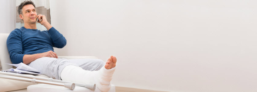 man with leg cast on the phone
